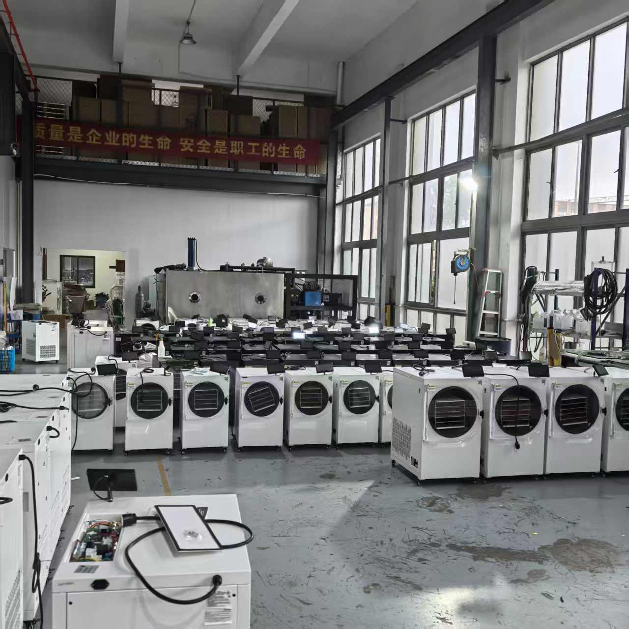 Compact H Series food freeze dryer manufacturing capacity compact food freeze dryer manufacturing capacity with many H Series units organized on the production floor