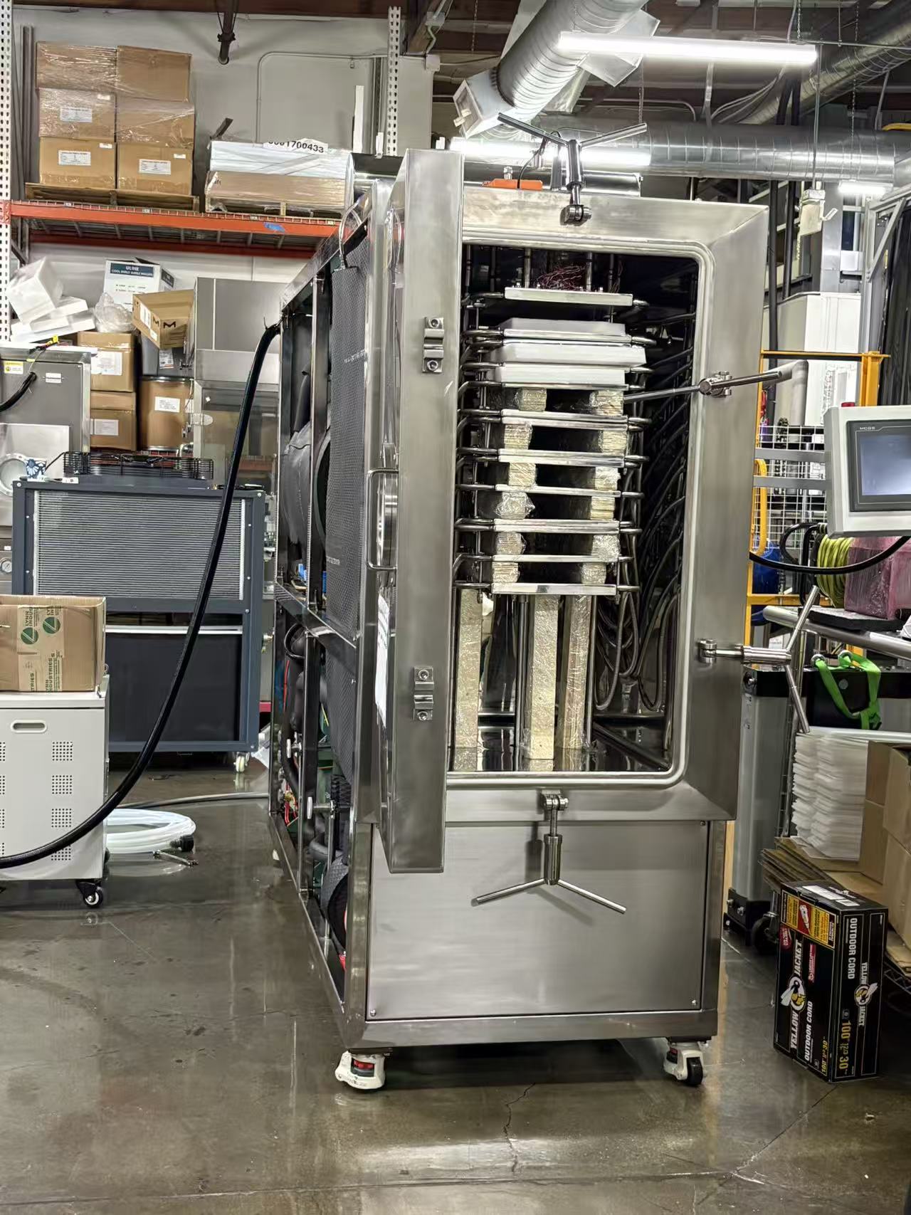 Open chamber of a 13-shelf GMP freeze dryer for peptide lyophilization