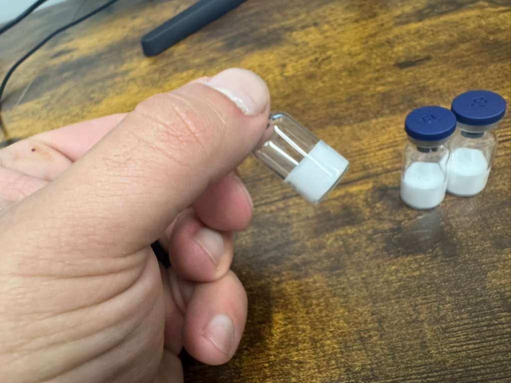 Close-up of a white peptide freeze-dried vial cake produced in a small-batch lyophilizer